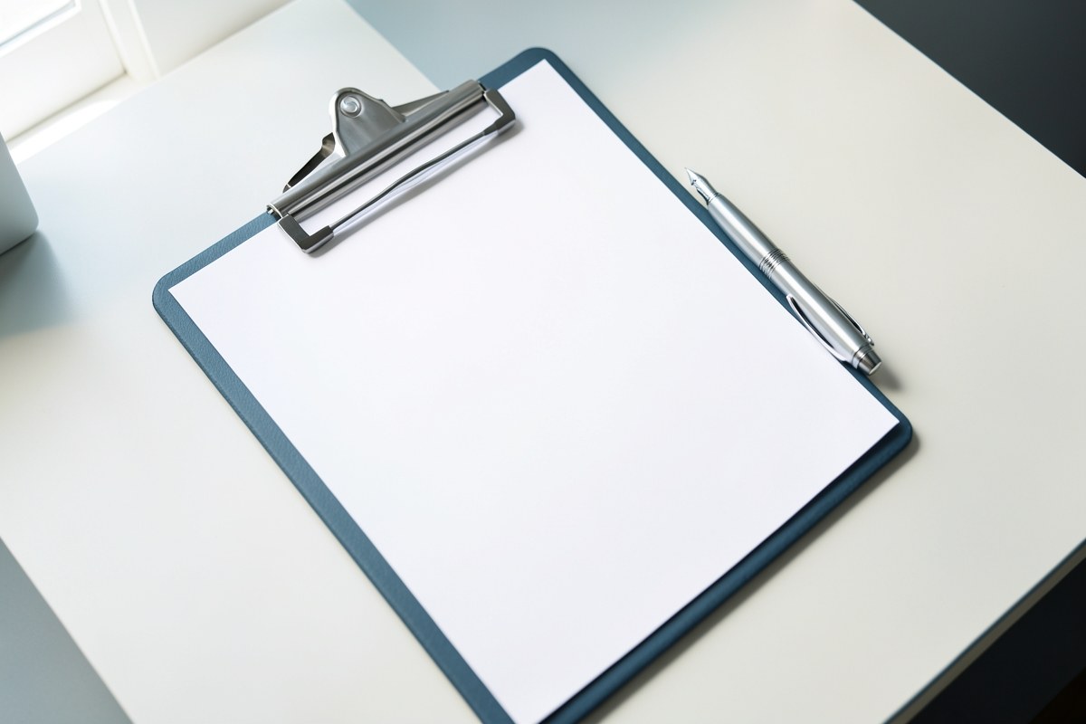 An open, empty checklist on a clipboard with a fountain pen next to it, ready for action on a clean desk, suggesting qualification steps.